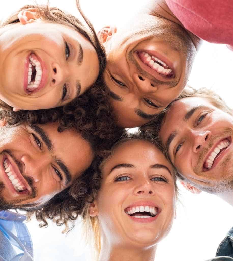 Smiling person showcasing white teeth after laser whitening treatment Hertford